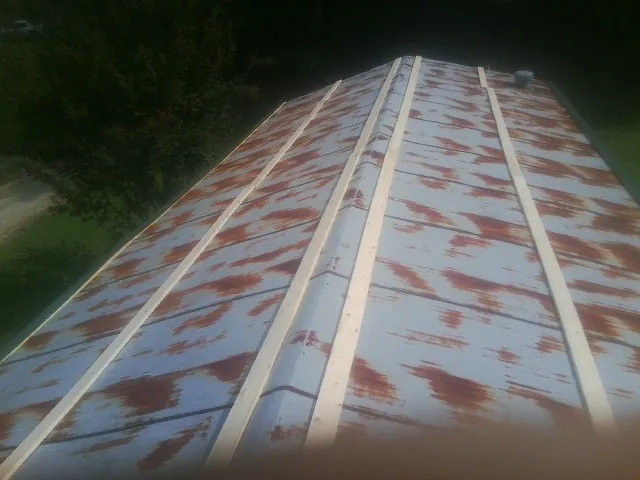 Rusted metal roof panels with new wood purlins before replacement — Storm Damage Roof Repair in Porter Corners by Roofing Brothers