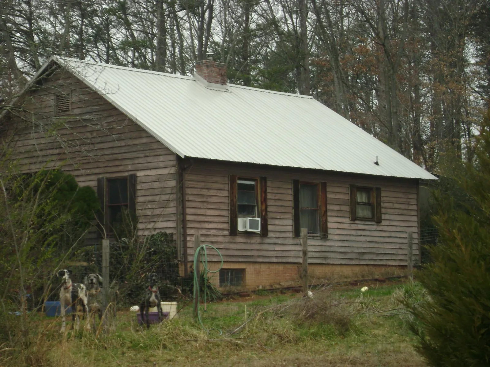 White metal roof on an old wood sided farmhouse, from a Metal Roof Installation job in Porter Corners